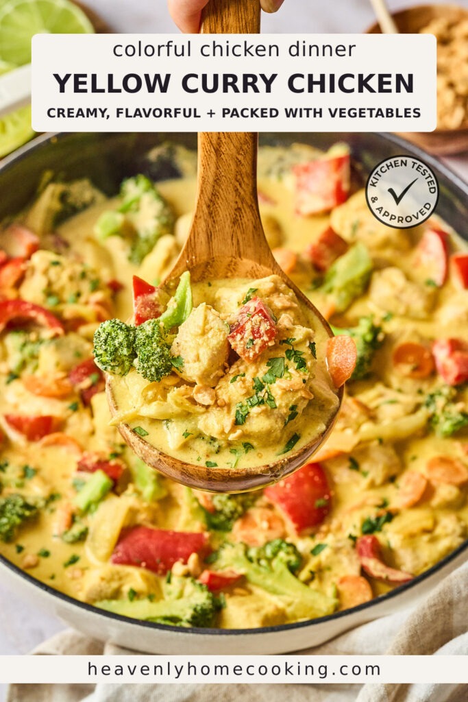 A wooden spoon lifts a scoop of creamy yellow curry chicken filled with tender chicken, broccoli, red bell peppers, carrots, and onions from a skillet. The Pinterest pin includes the text "Colorful Chicken Dinner Yellow Curry Chicken – Creamy, Flavorful + Packed with Vegetables." This vertical Pinterest pin features a homemade yellow curry chicken recipe from Heavenly Home Cooking.