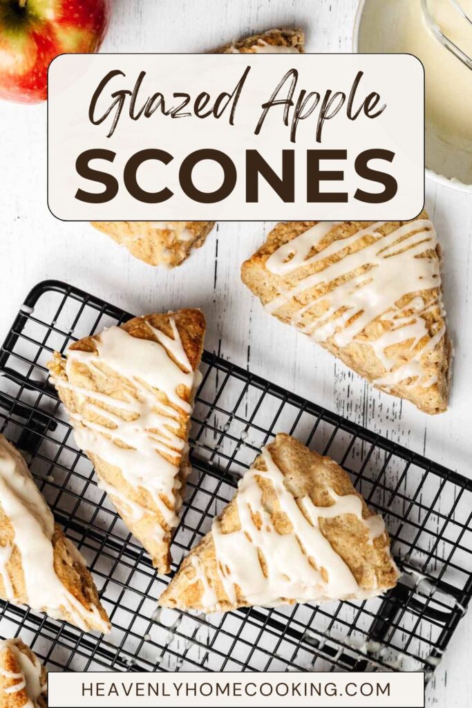 Vertical Pinterest pin for glazed apple scones featuring bakery-style apple scones drizzled with vanilla glaze on wire cooling racks, with a fresh apple in the background. The text overlay reads "Glazed Apple Scones," and includes the Heavenly Home Cooking logo.