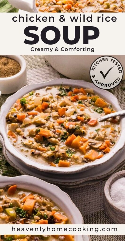 Bowl of creamy chicken and wild rice soup filled with chicken, wild rice, carrots, celery, mushrooms, and herbs. This is a Pinterest pin for a Heavenly Home Cooking recipe.