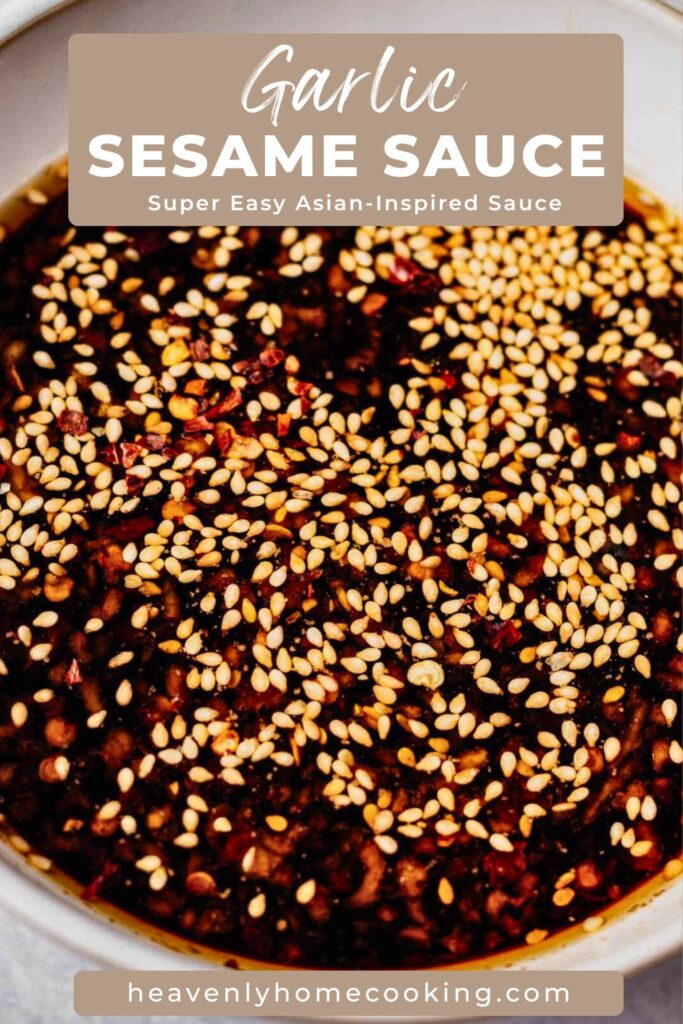 Close-up of homemade garlic sesame sauce topped generously with sesame seeds and red pepper flakes. Pin text reads “Garlic Sesame Sauce – Super Easy Asian-Inspired Sauce” with Heavenly Home Cooking branding.