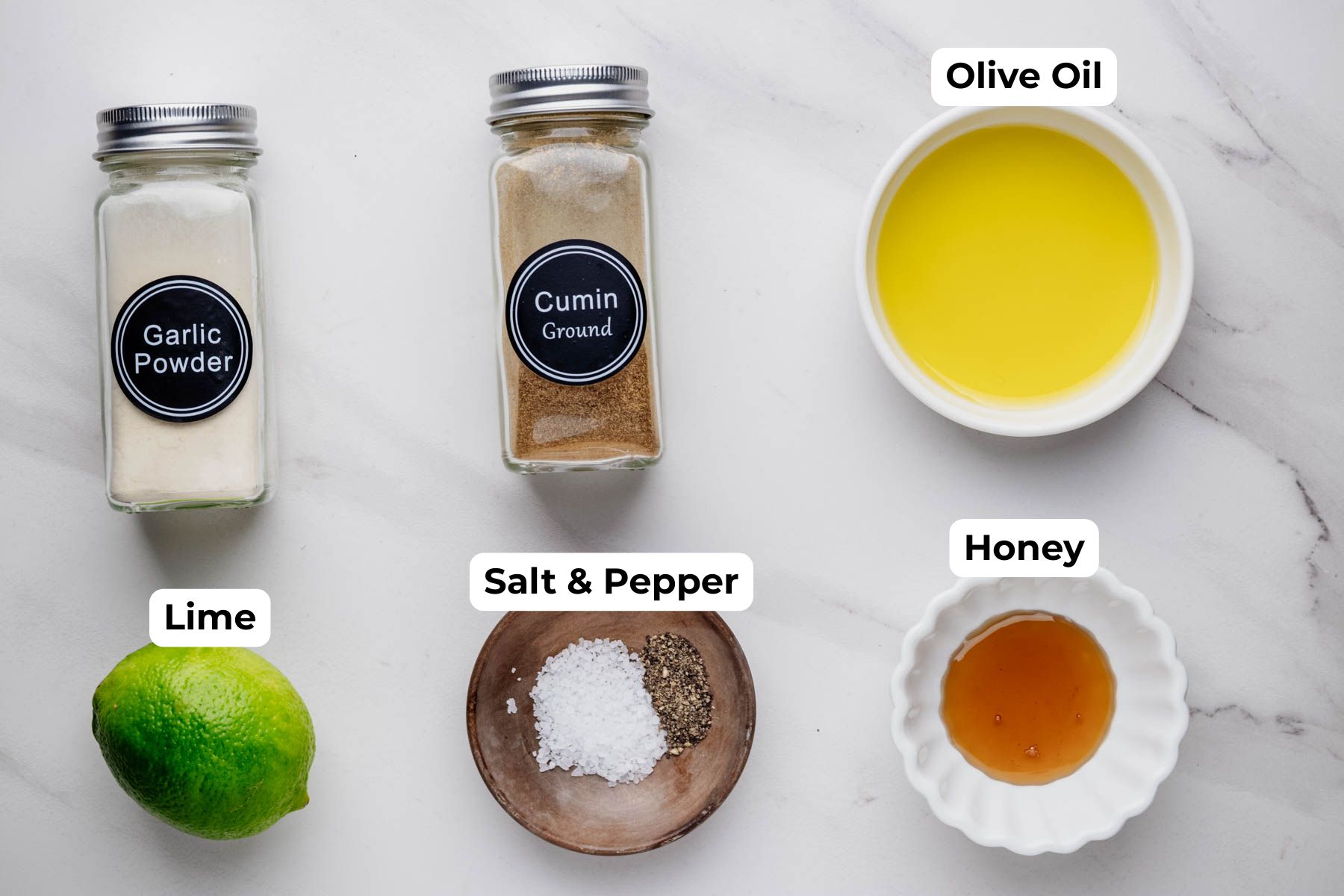 Labeled lime dressing ingredients, including olive oil, honey, lime, cumin, garlic powder, kosher salt, and black pepper.