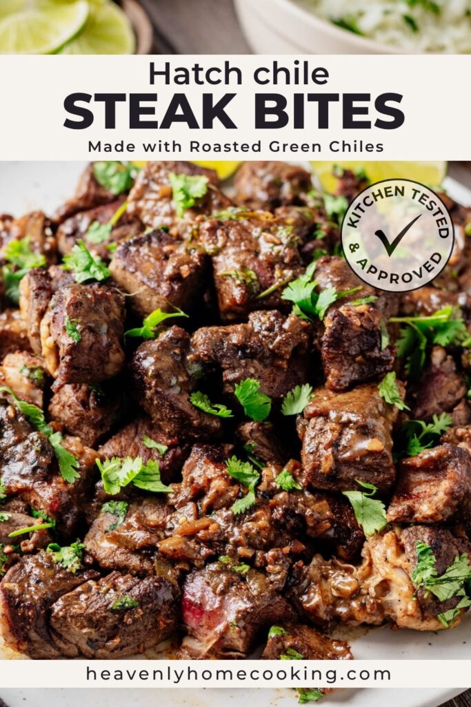 Close-up of browned Hatch chile steak bites garnished with cilantro, with lime wedges in the background. This is a Pinterest pin for a Heavenly Home Cooking recipe.