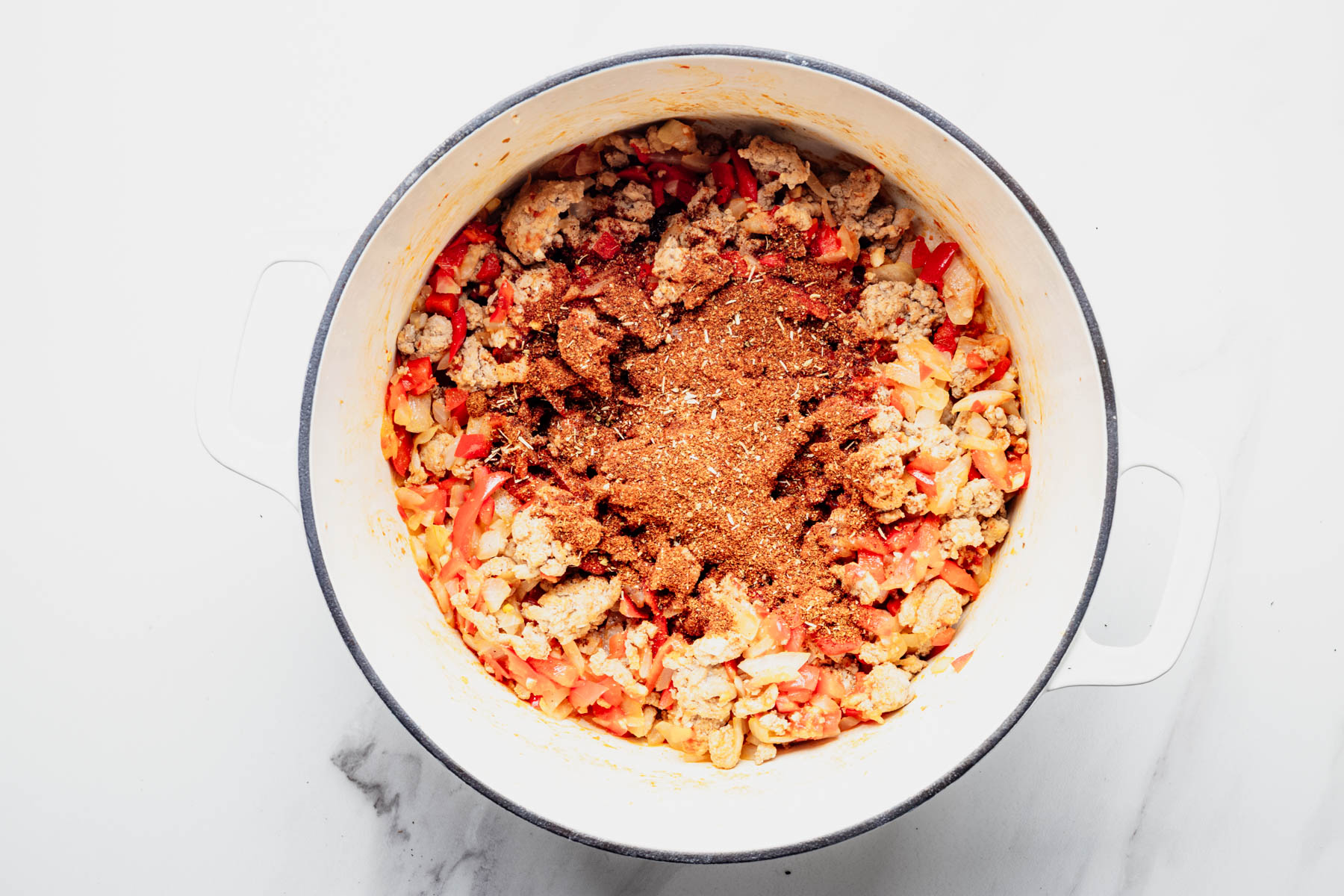Chili powder, cumin, smoked paprika, oregano, and cayenne added to the turkey mixture.