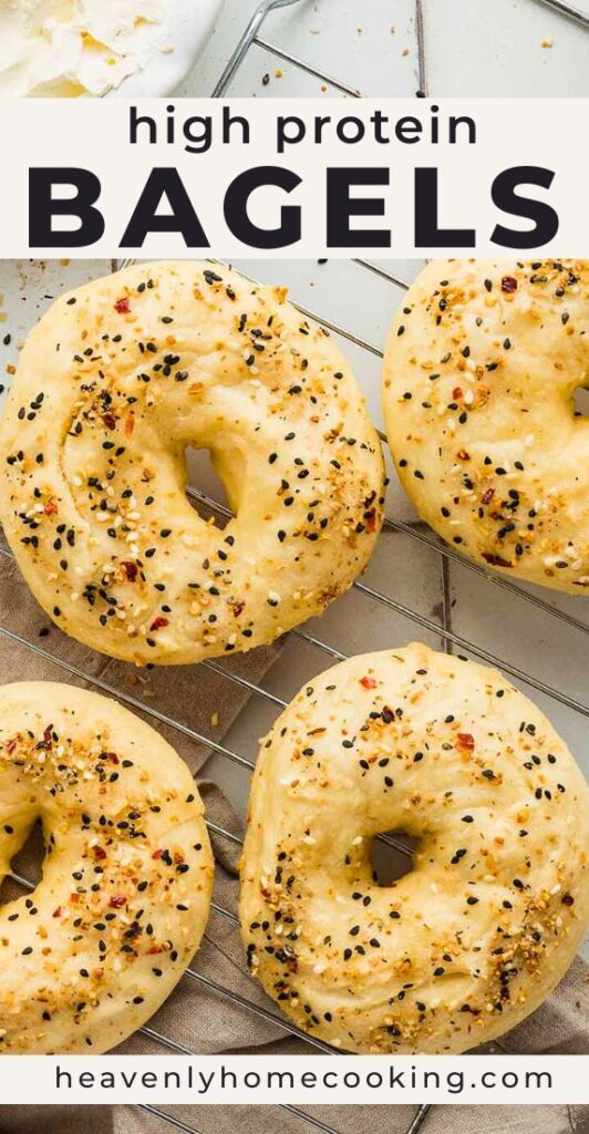 Pinterest pin for high-protein bagels featuring four homemade everything bagels cooling on a wire rack. The text overlay reads "High Protein Bagels." The image highlights soft, golden bagels topped with everything bagel seasoning and includes Heavenly Home Cooking branding.