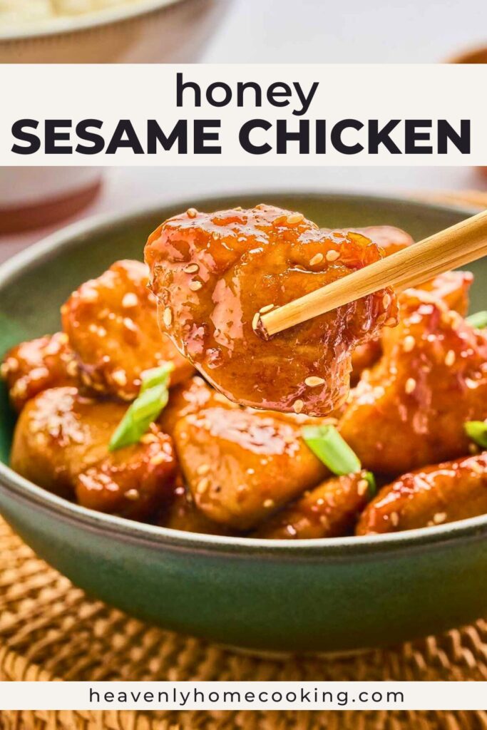 Sticky honey sesame chicken pieces glazed in a glossy sweet and savory sauce, sprinkled with sesame seeds and green onions, with one piece held by chopsticks. Pin text reads “Honey Sesame Chicken” with Heavenly Home Cooking branding.
