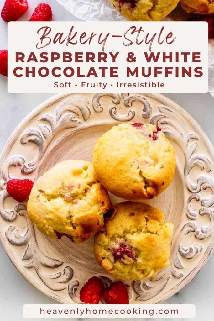 Bakery-style raspberry and white chocolate muffins with fresh raspberries arranged on a decorative plate. Text reads “Bakery-Style Raspberry & White Chocolate Muffins – Soft, Fruity, Irresistible.” Heavenly Home Cooking.